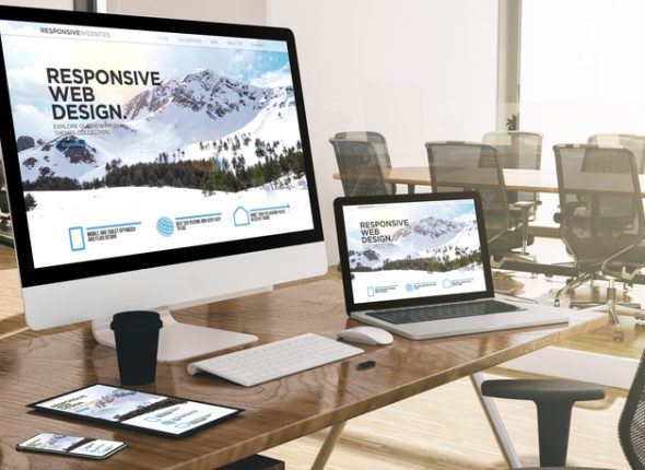 computer, laptop, tablet, and phone with responsive web design website at office mockup